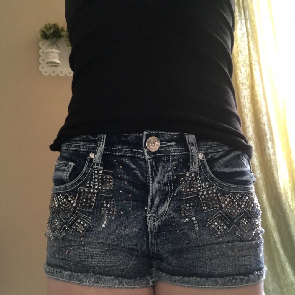 Jean shorts with gems on front and back pockets.